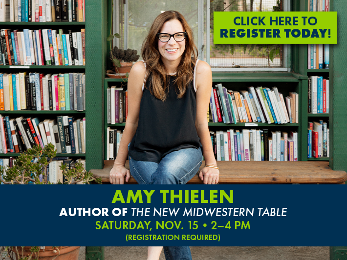 Author Amy Thielen in front of a stack of books.