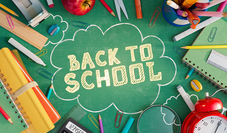 Chalk board with school supplies all around it with chalk words saying 