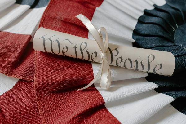 Wrapped scroll with the words "We the people" laid on a bunting.