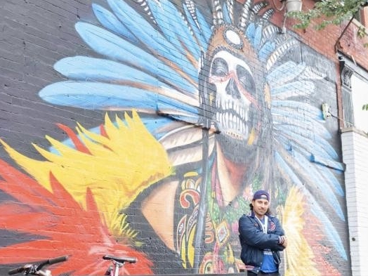 Colorful mural on a brick building.