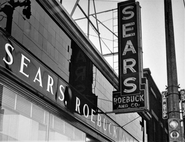 Black and white photo of Sears Roebuck and Co. signage.