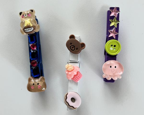 Photo-holding clothespin magnets decorated with charms.