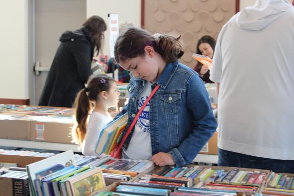 Child browsing through books.