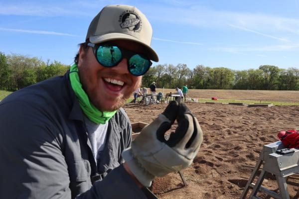 Dale Simpson holding an archaelogical find.