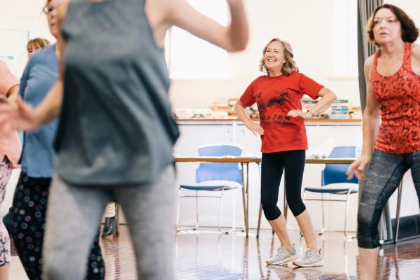 Adults dancing in a group setting.