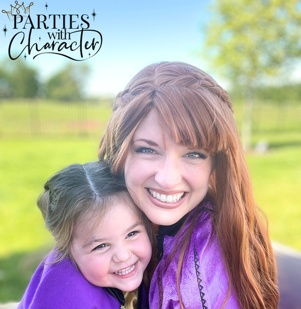 Anna smiling with a child.