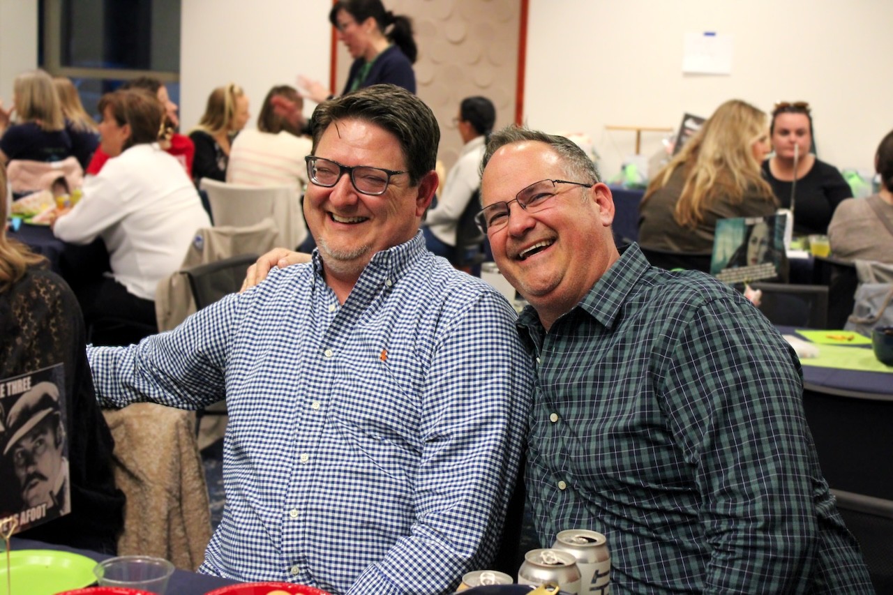 Two men smiling while attending Plot Twist Trivia Night