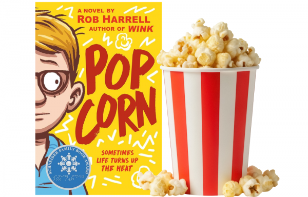 Popcorn bucket next to the book 
