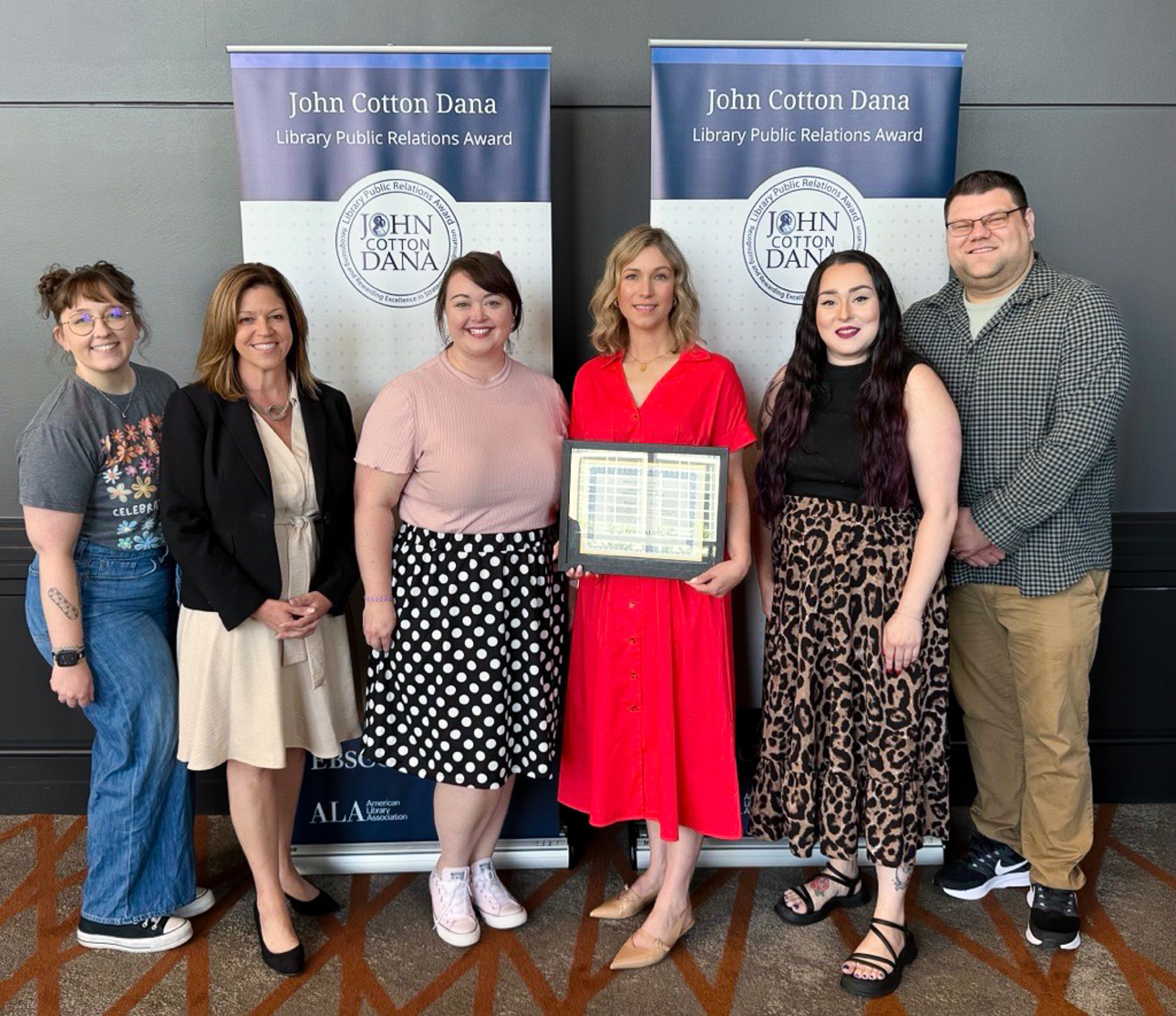 Geneva Public Library staff receiving the John Cotton Dana Award at the 2026 ALA Annual Conference in Chicago. Pictured L-to-R: Lexy Rodriguez, Outreach Coordinator; Christine Lazaris, Director; Jordan McNamee, Outreach Librarian; Chaz Baechler, PR Coordinator; Isabel Munoz, Marketing Specialist; Alex Hanold, Marketing Coordinator.https://about.ebsco.com/about/scholarship-awards/john-cotton-dana