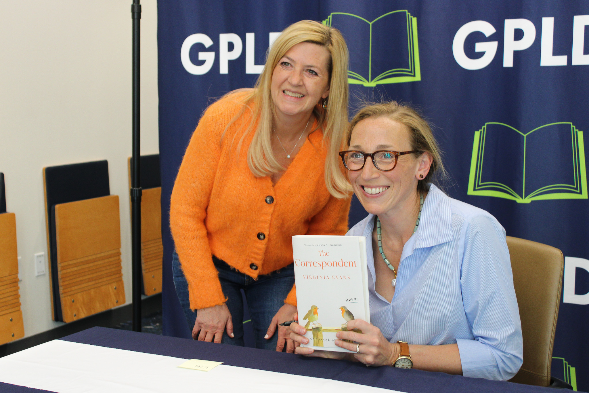 Viriginia Evans smiling with a patron for a photo
