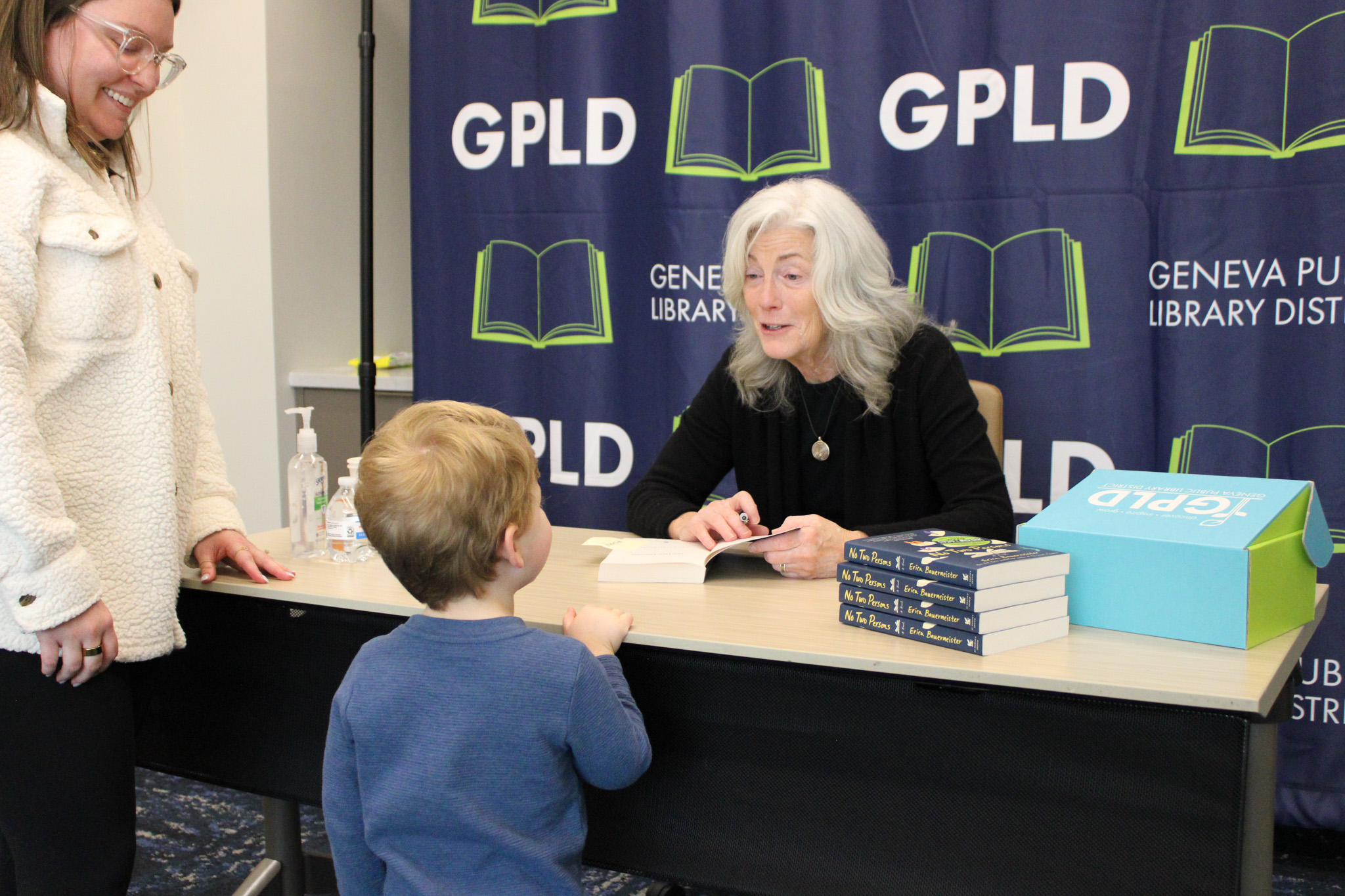 A little boy and his mother getting their books signed.